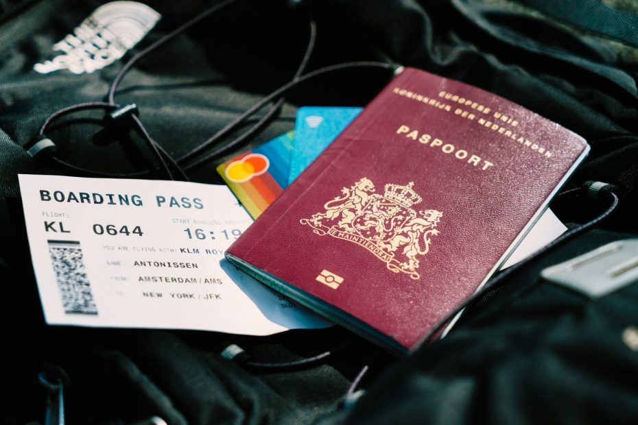A passport and boarding pass resting on a travel bag